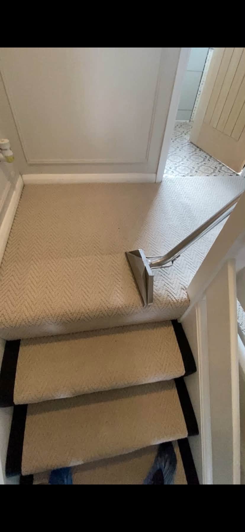 Industrial extraction tool cleaning a grey carpet